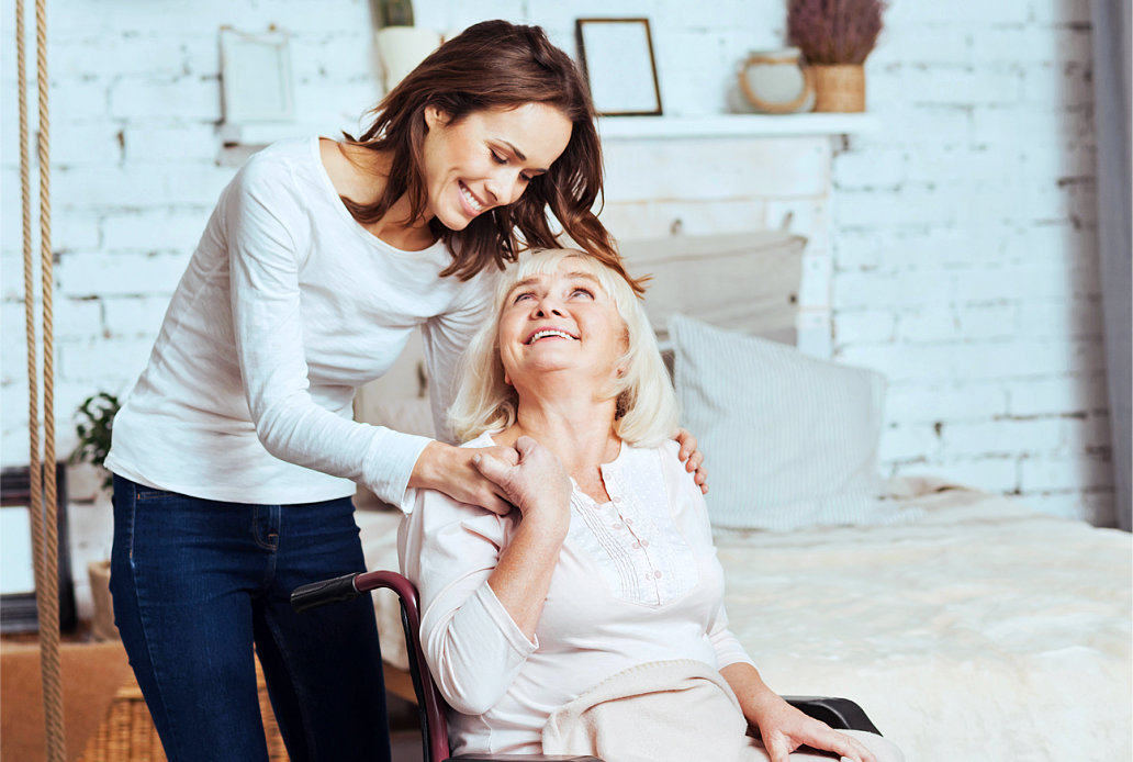 senior woman on a wheelchair with her caregiver